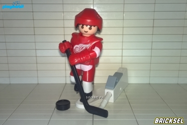 Игрок Detroit Red Wings с клюшкой и ударной установкой для запуска шайбы